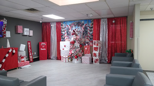 A beautifully decorated holiday event space featuring a Christmas tree and themed decorations.