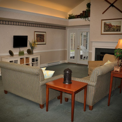 A cozy living room featuring a comfortable sofa, coffee table, and fireplace, creating a welcoming atmosphere.