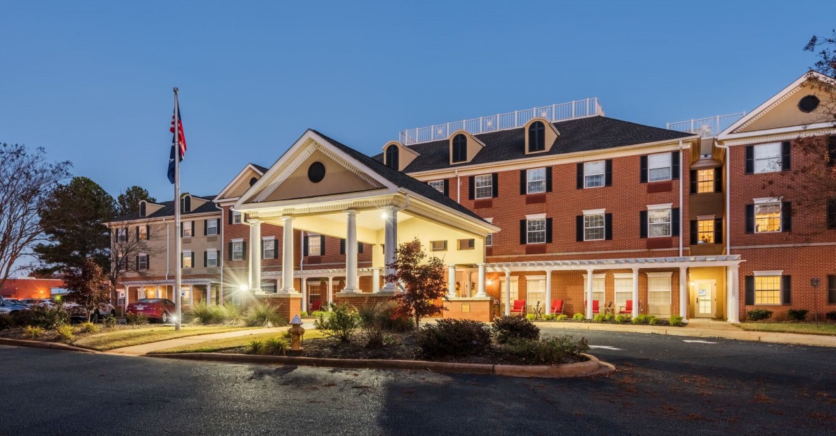 An elegant hotel building illuminated in the evening.