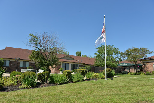 A peaceful residential building with a flag flying against a clear blue sky.