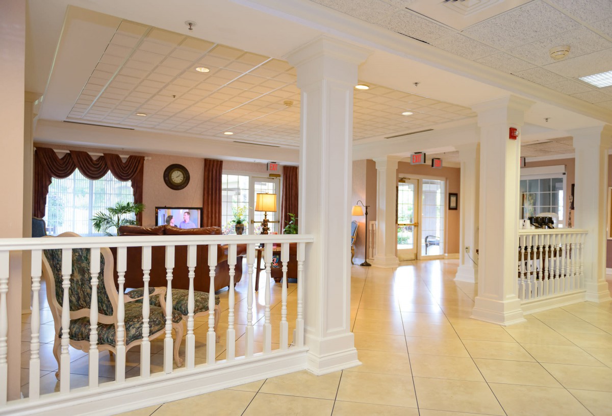 A spacious and elegantly designed lobby area with columns and comfortable seating.