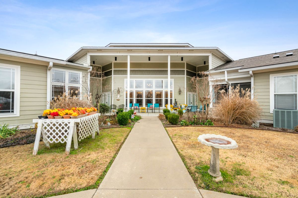 A beautiful residential building with a landscaped garden and walkway.