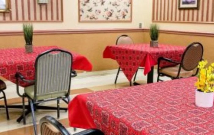 A cozy restaurant interior featuring red tablecloths on neatly arranged tables.