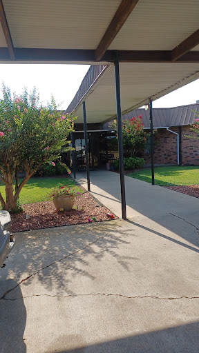 A view of a welcoming home entrance with a landscaped yard.