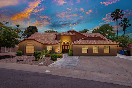 A beautifully designed house showcasing elegant architecture under a vibrant evening sky.