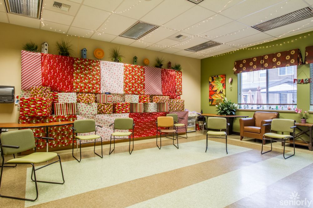 A brightly decorated waiting room with chairs lined against a vibrant wall.