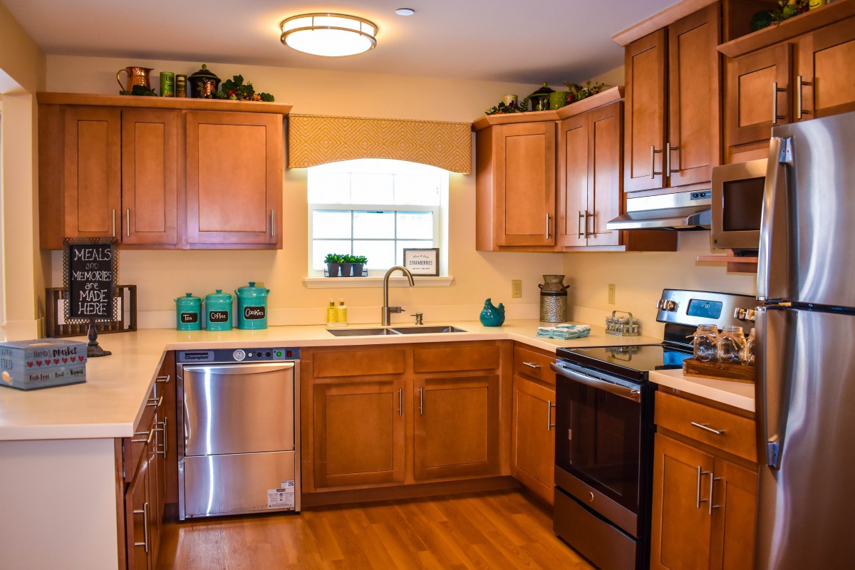 A cozy kitchen with wooden cabinets and modern appliances.