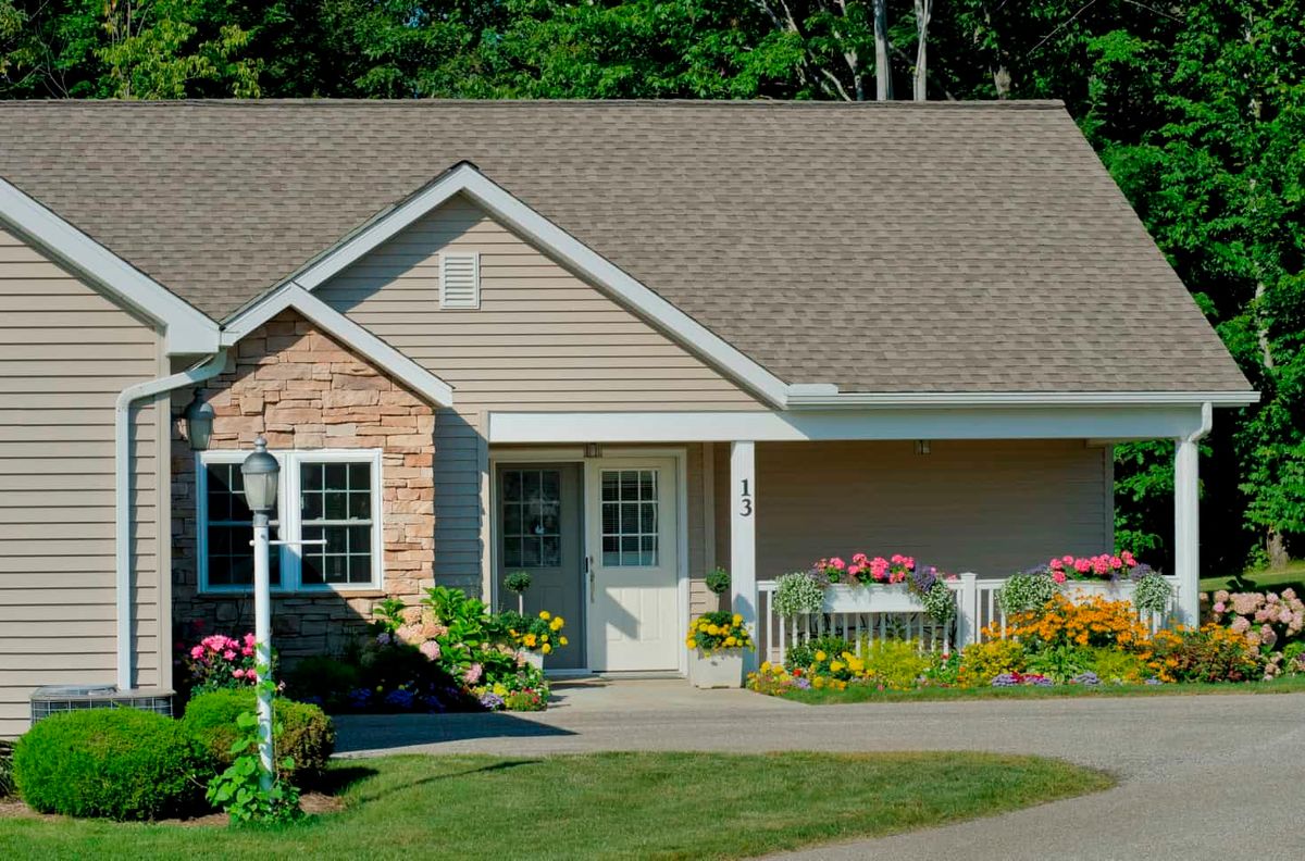 A charming suburban house with a well-maintained garden and front yard.