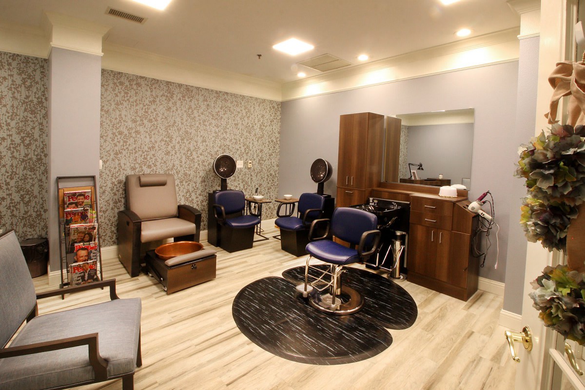 A modern salon interior with styling chairs and mirrors.