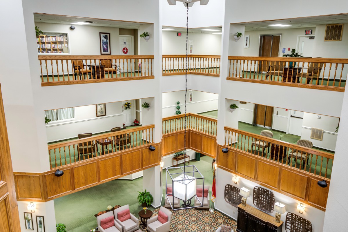 A modern atrium featuring multiple balconies overlooking a spacious lobby.