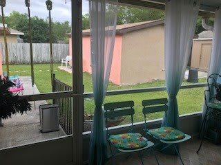 A cozy patio with two chairs overlooking a backyard garden.
