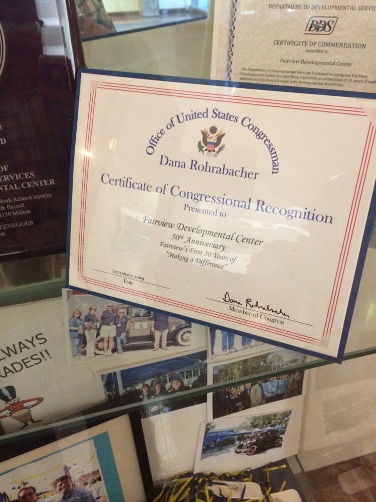 A Certificate of Congressional Recognition displayed among other items.