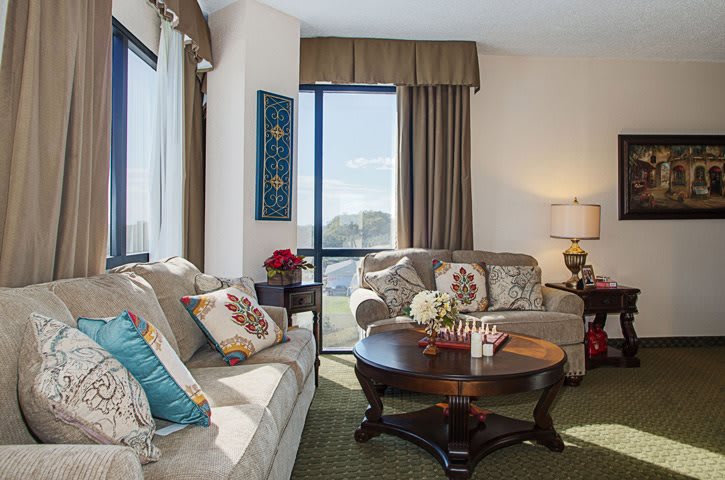 A cozy living room with stylish decor, featuring comfortable sofas and a wooden coffee table.