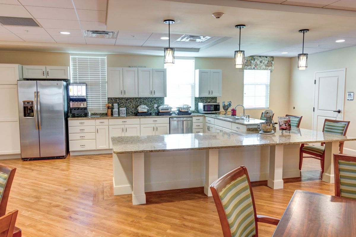 A modern kitchen interior with white cabinets and a spacious countertop.