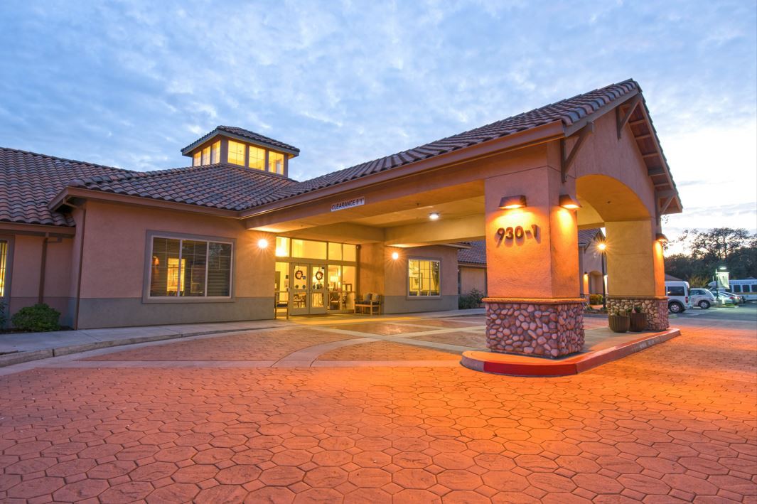 A well-lit hotel entrance during the evening with a welcoming ambiance.