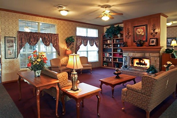 A cozy living room with a fireplace and comfortable seating.