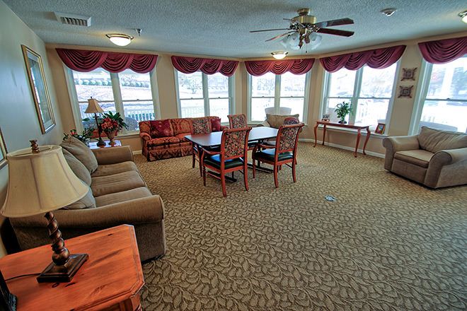 A spacious living room with comfortable seating and large windows.
