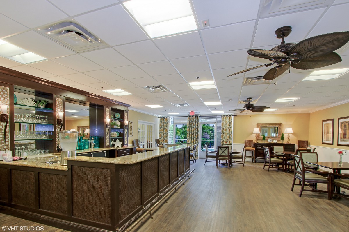 A spacious indoor bar area with wooden counters and seating.