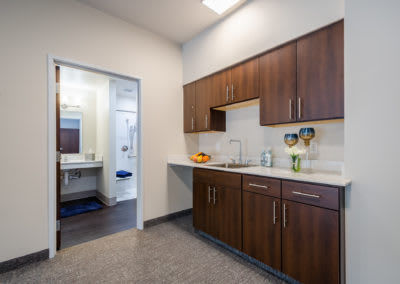 A modern kitchen interior with wooden cabinets and a sink.