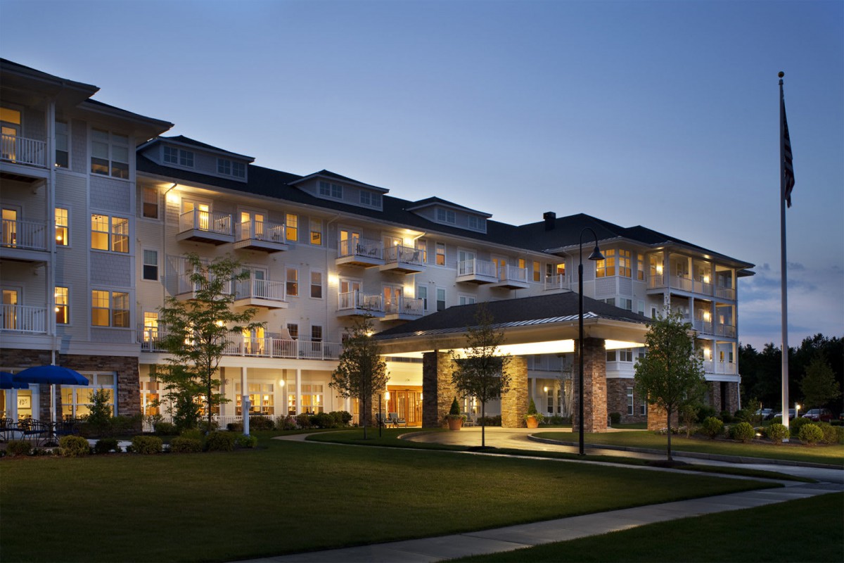 A well-lit residential building in the evening.