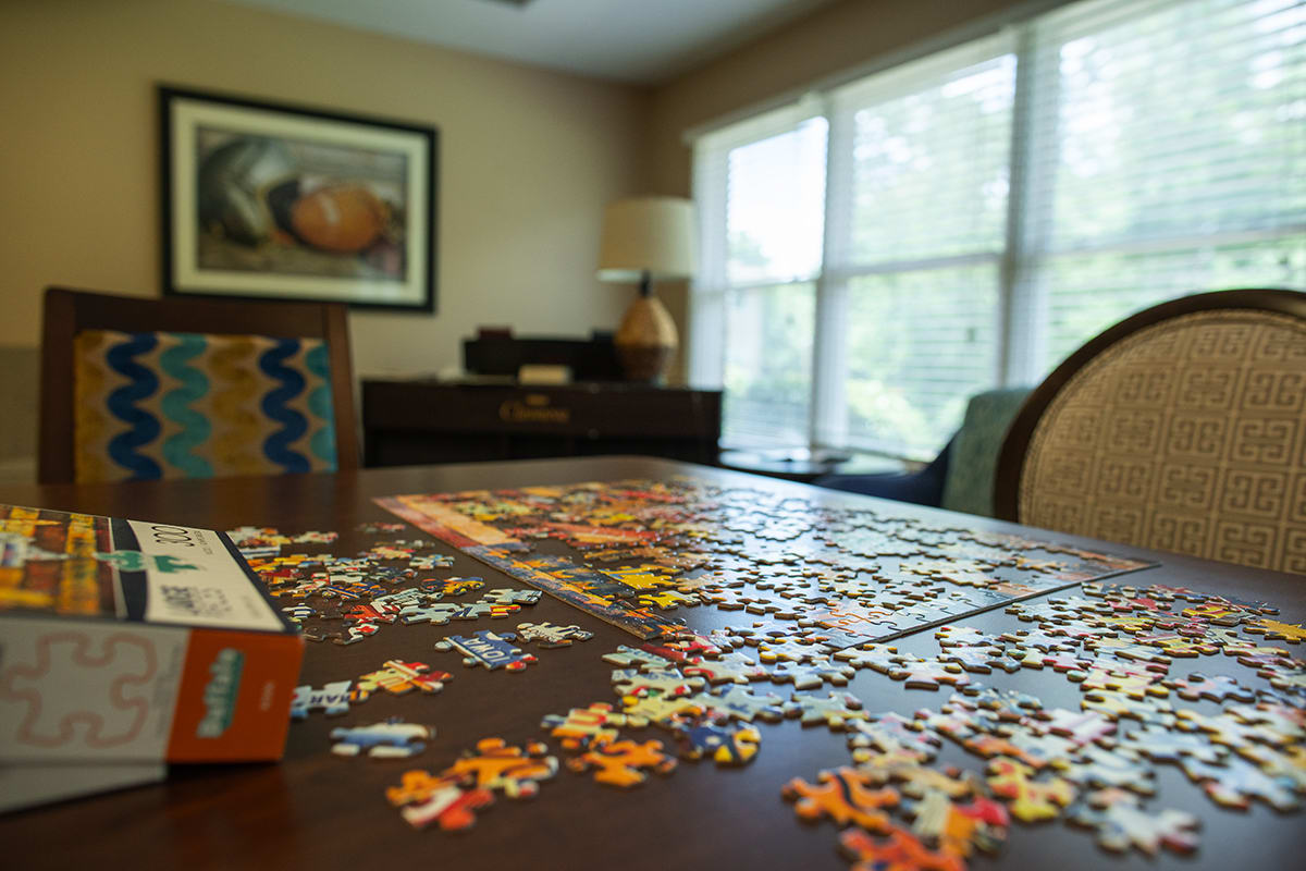 A cozy living room with a puzzle partially assembled on the table.