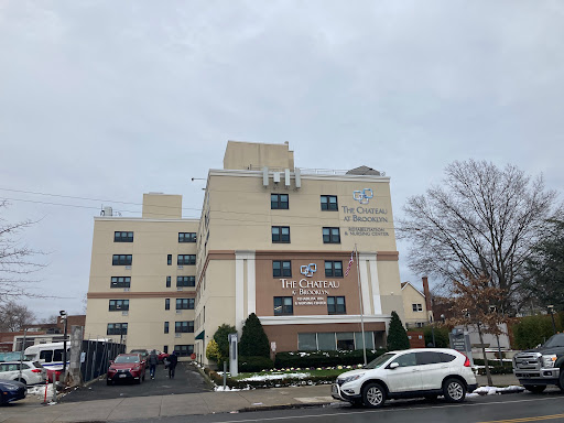 A modern healthcare facility with a welcoming entrance and cloudy sky.