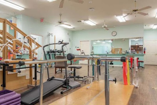 A well-equipped rehabilitation gym featuring various exercise machines and rehabilitation tools.