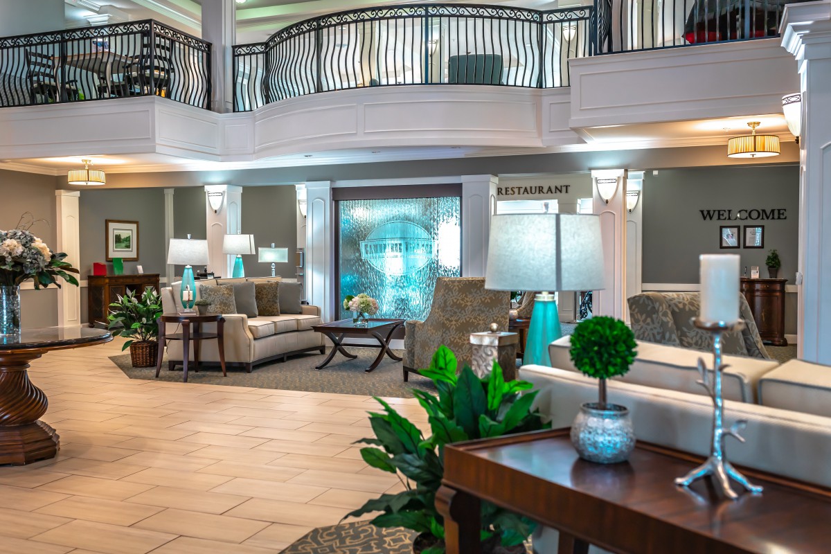 A spacious and elegantly designed hotel lobby featuring comfortable seating, stylish decor, and ambient lighting.