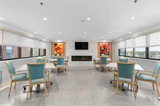 A modern dining area featuring light-colored walls, stylish furniture, and vibrant artwork.