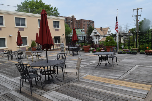 A serene outdoor patio with tables and umbrellas, perfect for dining or relaxation.