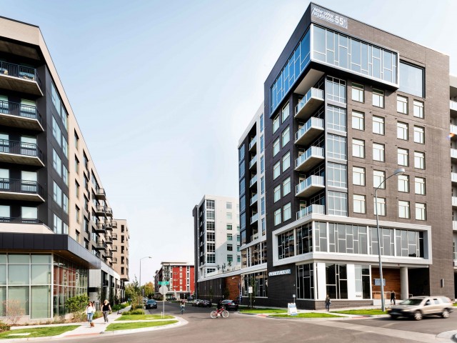 A view of modern apartment buildings along a city street.