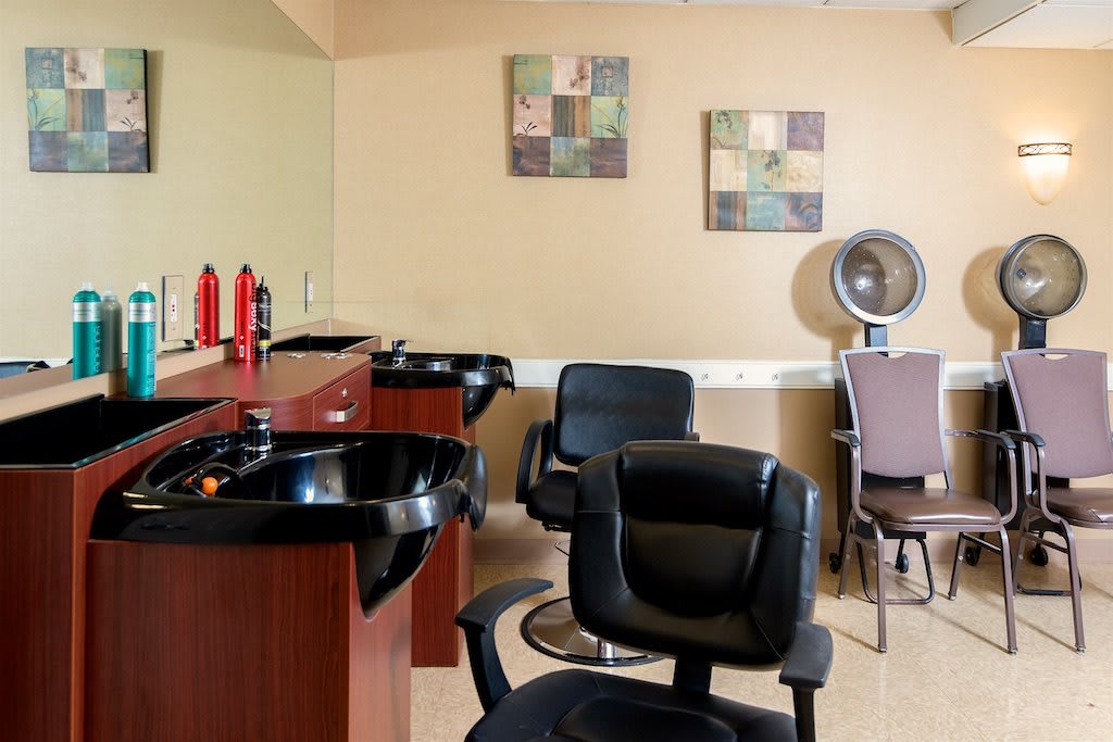 A modern salon interior featuring hair washing stations and styling chairs.