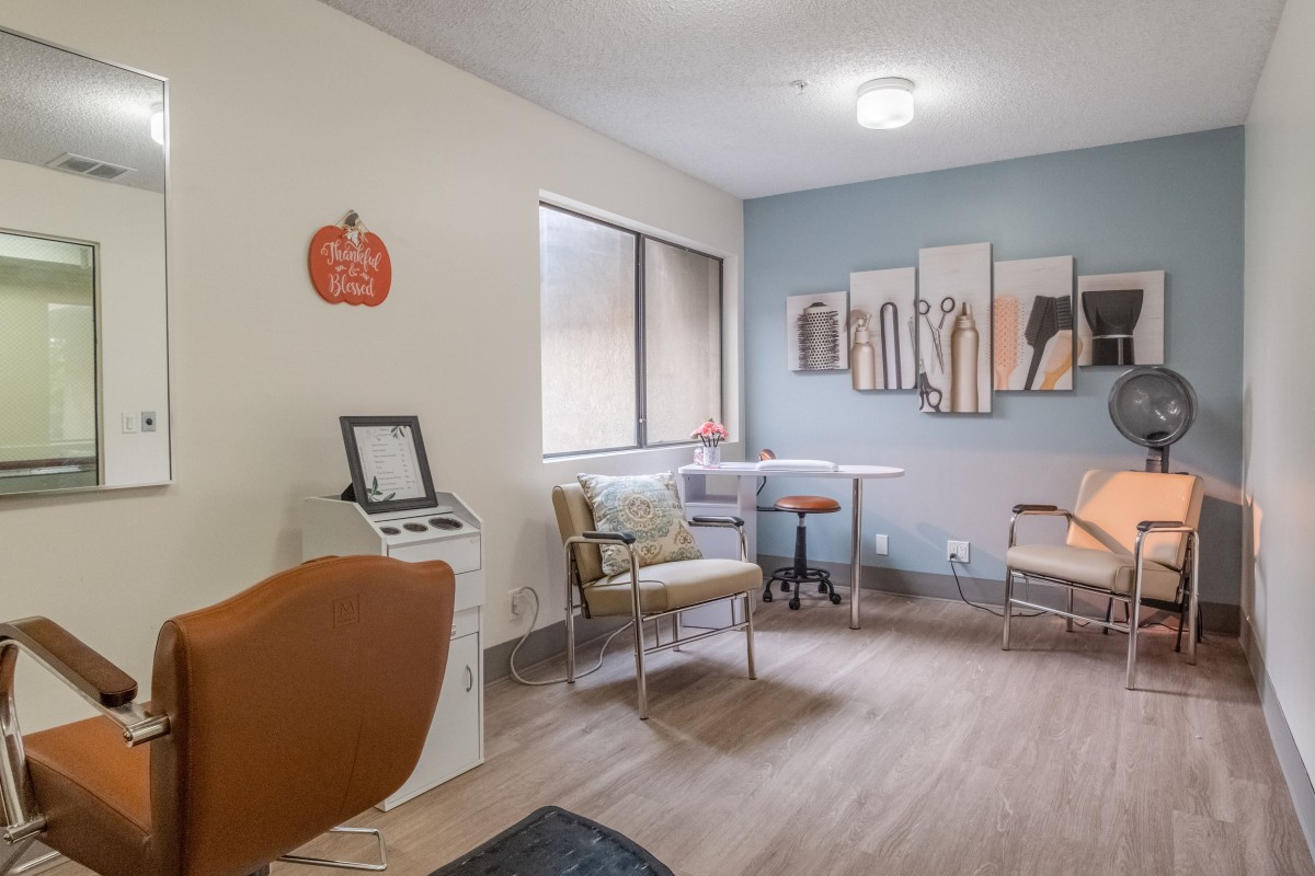 A cozy waiting room with modern furniture and decorative artwork on the wall.