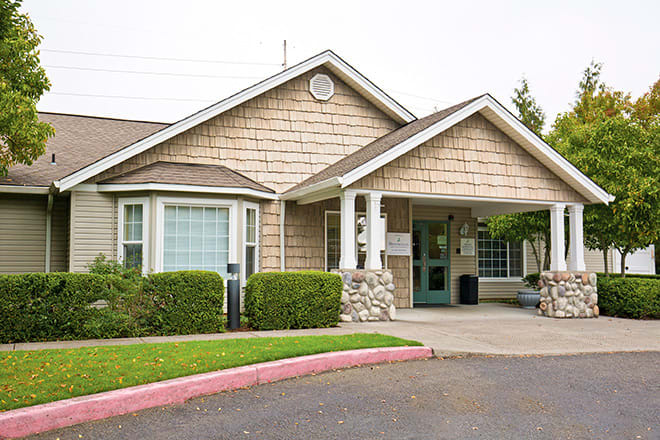 A residential building with a well-maintained entrance and landscaping.