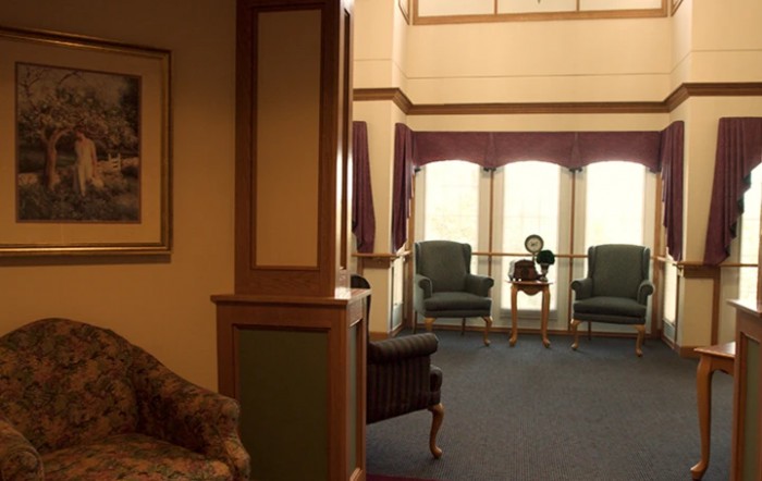 A cozy waiting area with seating and large windows.