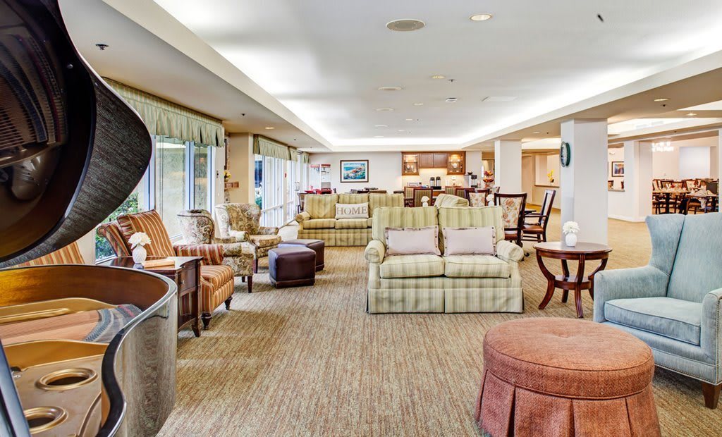 A spacious living room featuring comfortable seating arrangements and stylish decor.