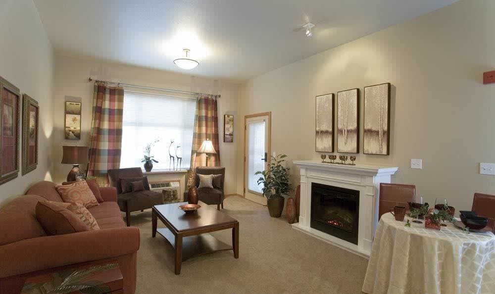 A cozy living room featuring a fireplace, comfortable seating, and tasteful decor.