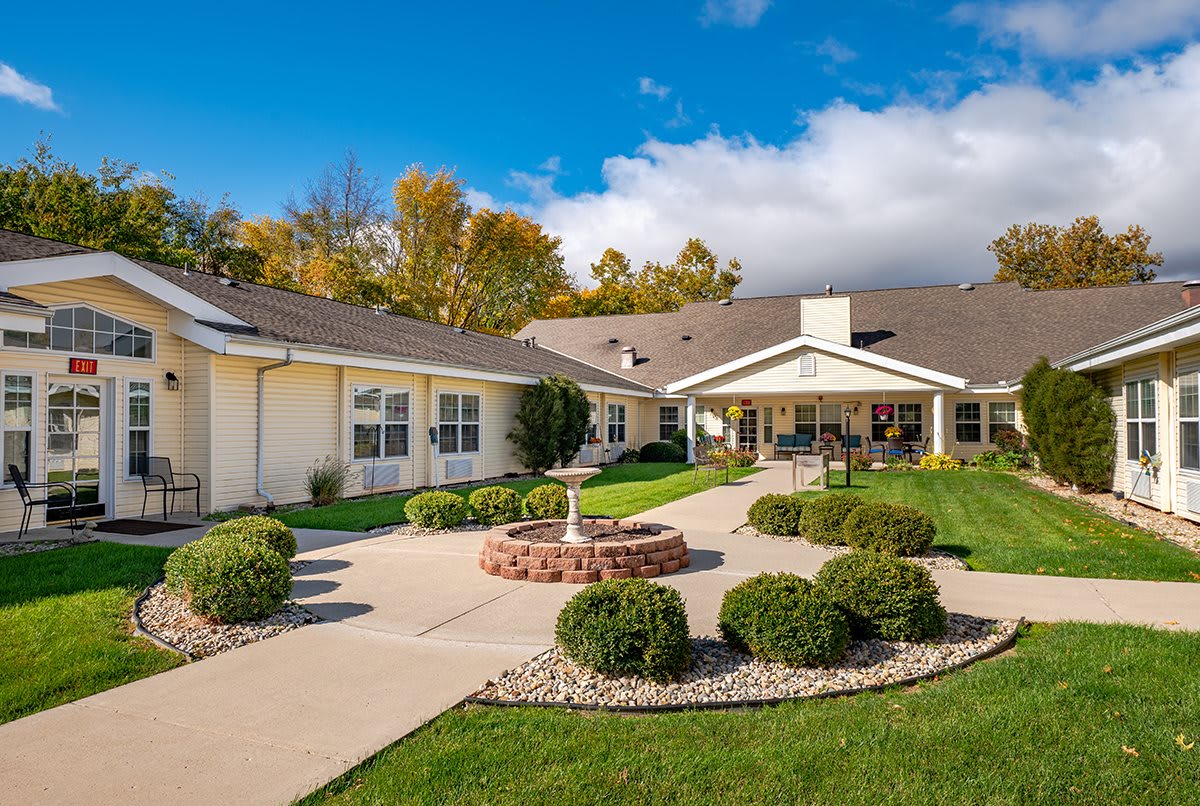 A beautifully landscaped residential building with a garden.