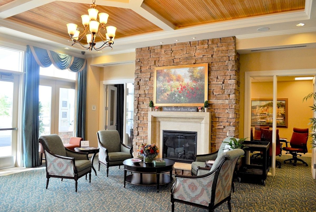 A cozy living room with a brick fireplace and comfortable seating arrangement.