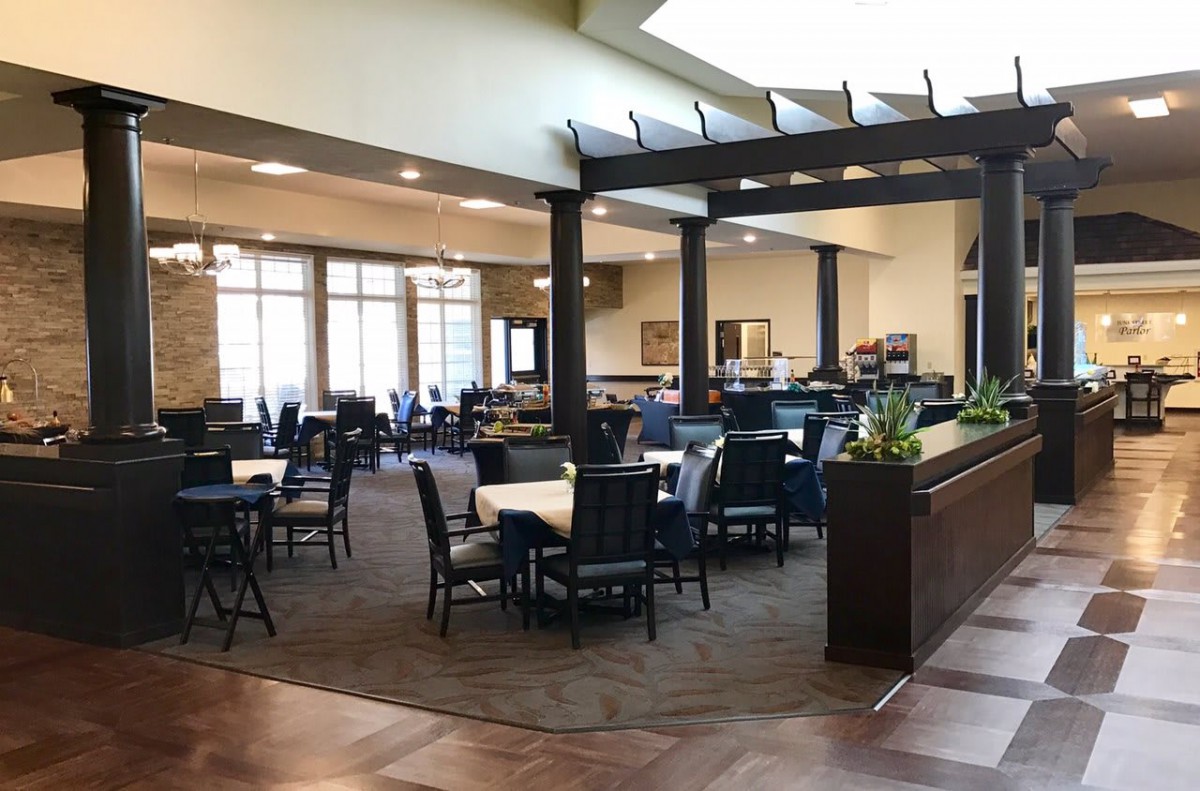 A spacious and modern dining area with neatly arranged tables and chairs.