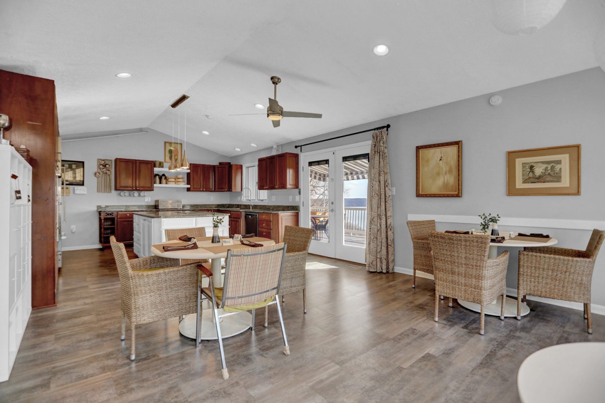 A modern open-concept kitchen and dining area featuring wood flooring and ample natural light.