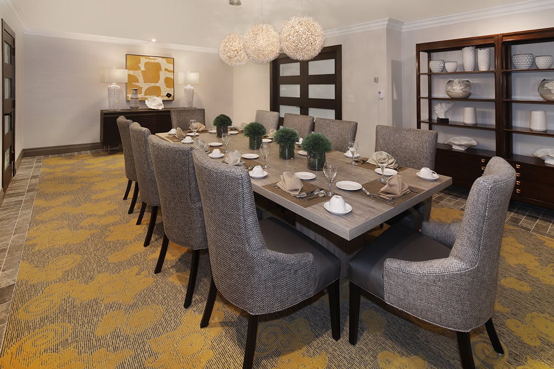 A modern and elegant dining room with a stylish table set for a meal.
