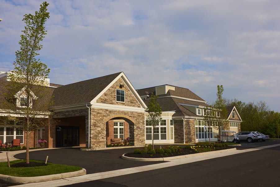 A suburban residential building with a stone facade and modern architecture.