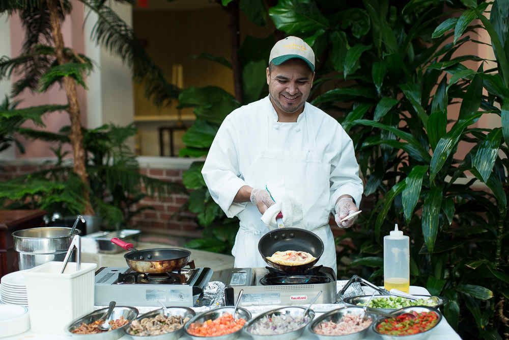 A chef preparing dishes at an outdoor cooking station.