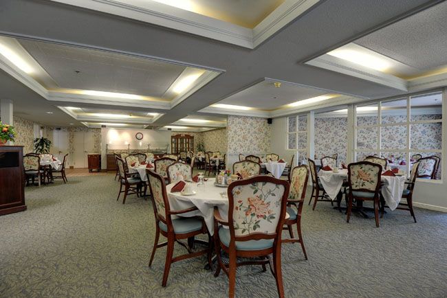 An elegant dining room with beautifully decorated tables and chairs, set in a refined interior.
