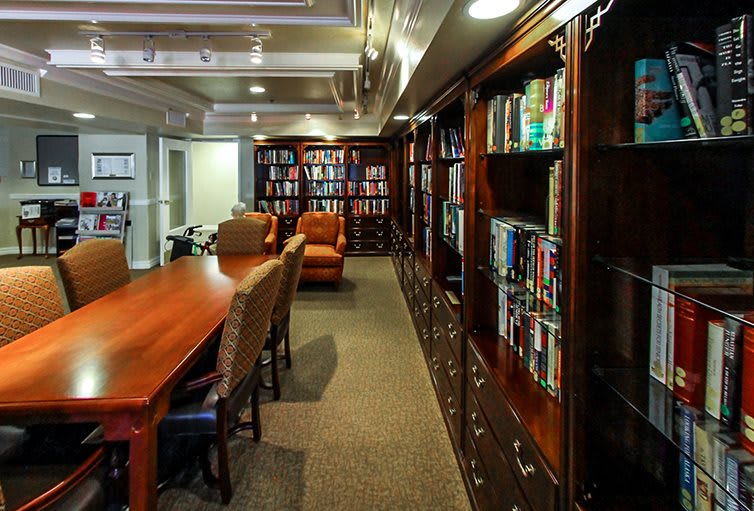 A cozy library with bookshelves and a reading area.