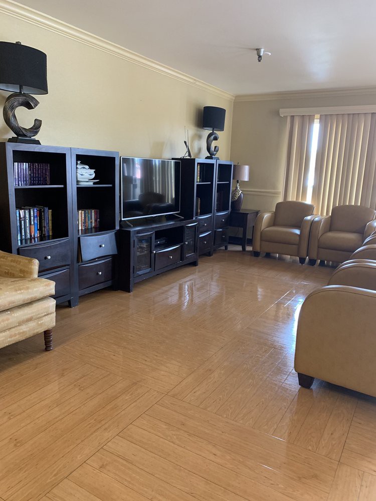 A cozy living room with a modern entertainment center and comfortable seating.