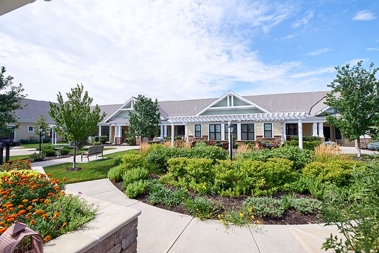 A well-maintained residential building with beautiful landscaped gardens and pathways.