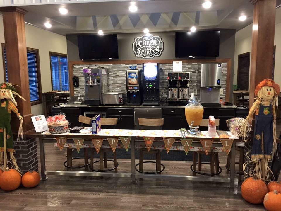 A cozy coffee shop setup with a welcoming counter and decorated invite table.