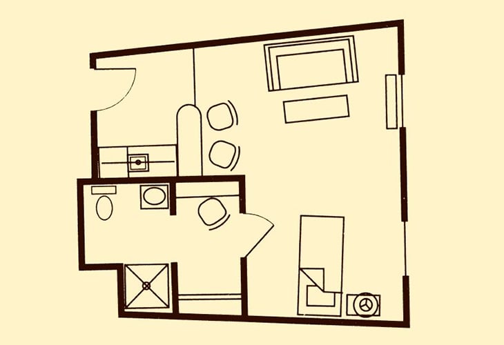 A floor plan of a small apartment showing the layout of the living room, kitchen, bathroom, and furniture arrangement.